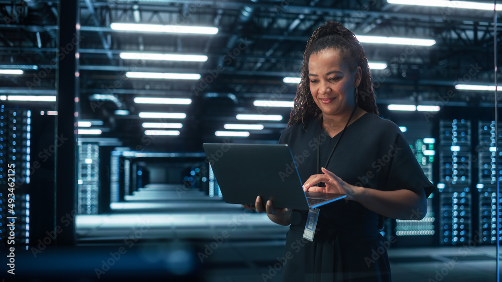 Aufkleber black female chief technology office using laptop computer, standing in big office data center. syst