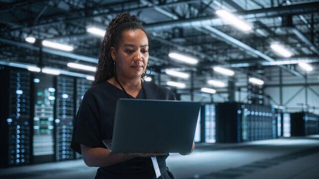 Office: Successful Businesswoman in Stylish Clothes Working on Laptop and Looking at the Screen. Stylish Female Executive Working Late on Computer to Achieve Best Results - Powered by Adobe