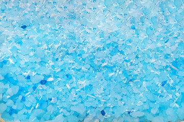 Scented blue bath salt or body scrub. Natural skin care product. Hygienic routine.