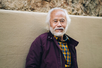 portrait senior asian man with white hair and beard, smiling