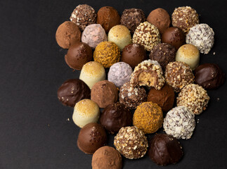 chocolate truffles on black background