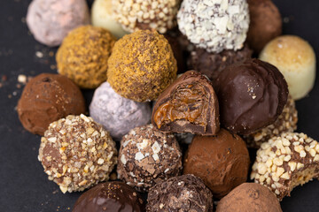 chocolate truffles on black background