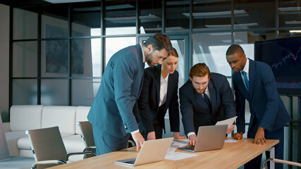 Young people in suits discussing in the office