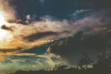 Dramatic sky clouds on sunset or evening time with top of tree.