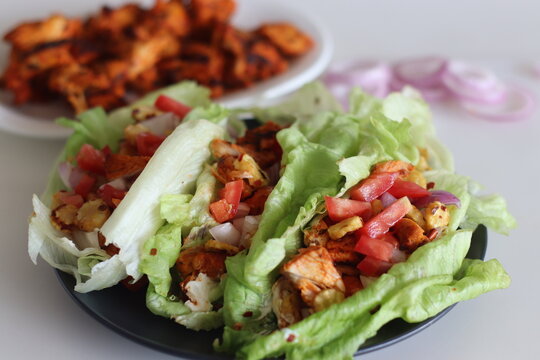 Lettuce chicken wrap. Tandoori chicken bites, sauteed baby corn, fresh cut tomatoes and onions tossed and wrapped in iceberg lettuce leaves.