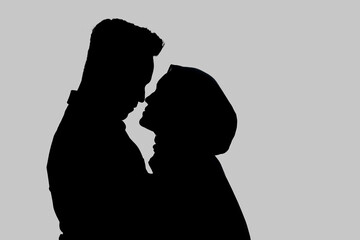 Silhouette image of romantic muslim couple. Isolated on gray background