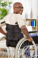 man in wheelchair at home or in office