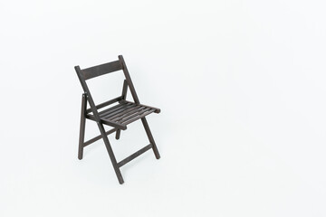 Black wooden folding chair with backrest on white background