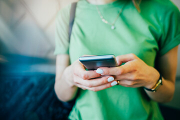 Close-up young woman using mobile phone outdoors