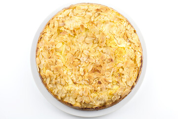 Baked cake with almonds on white background