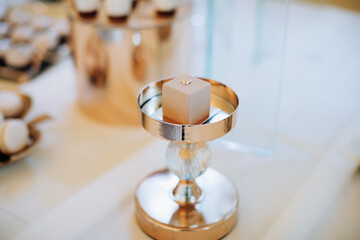 Sweet cake on a golden tray on the dessert table. Elegant decoration