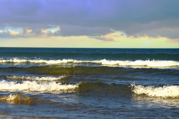 Waves in sea during a storm on sunset. Waves against backdrop of a stormy sky in sea. Waves at sea...