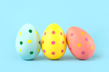 Happy Easter. Close-up of three colored easter painted eggs