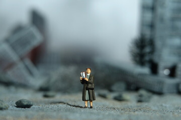Miniature people toy figure photography. A woman holding photo frame, searching for missing person...