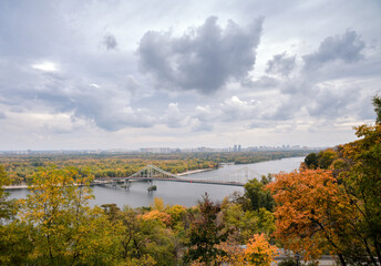 Obraz premium Autumn landscape of Kyiv. Colorful trees under a dramatic cloudy sky
