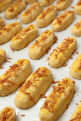 The golden yellow Kaasstengels (Dutch cheese finger cookies) fresh from the oven