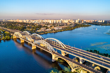 Fototapeta na wymiar Aerial view of the Darnytsia arch bridges across the Dnieper in Kiev, Ukraine, before the Russian invasion