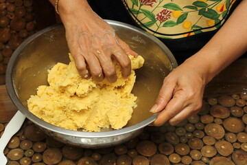 The lady's hand kneading the Kaasstengels (Dutch cheese finger cookies) dough