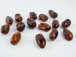 dates scattered isolated on a white background. healthy fruit ramadan concept