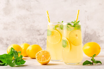 Lemonade with lemon, mint and ice cubes in glass