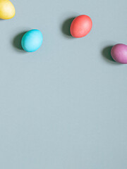 Colorful painted Easter eggs on the grey background. Top view. Copy space	