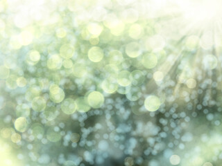 spring abstract green blurs background with sunny beams shiny bokeh