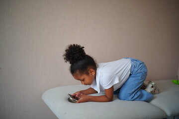 portrait of mixed race kid using mobile phone.