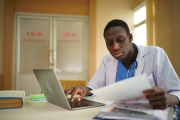 Fototapeta premium Portrait of mature, Black doctor sitting in medical office