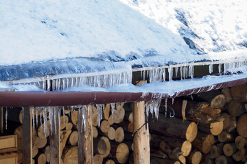 Eaves weighed down with ice in winter.