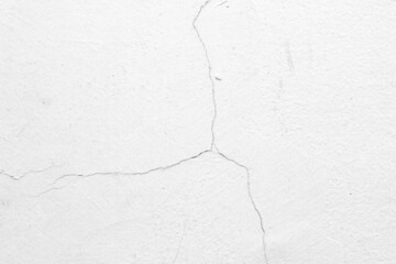 Fototapeta premium The white concrete wall is cracked, the paper is cracked