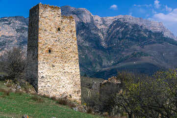 An abandoned medieval town. Military and residential ancient towers built of stones. Landscape in...