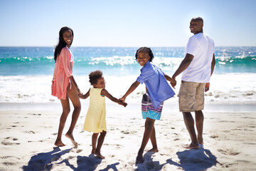 The ocean looks amazing. An african-american family enjoying a day at the beach together. - Powered by Adobe