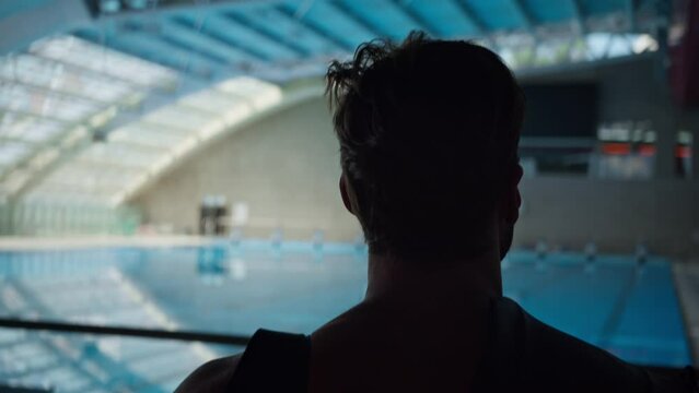 Male swimmer standing in the front of the pool