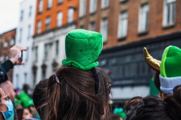 Saint Patrick's day parade in Dublin 2022, green hats in the crowd and people taking photos