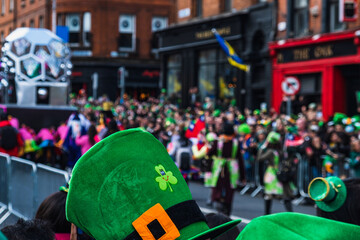 Fototapeta premium Saint Patrick's day parade in Dublin 2022, green hat with clover in the crowd