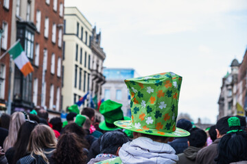 Saint Patrick's day parade in Dublin green hat with clover in the middle of the crowd, irish flag...