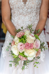 
March 2022, bride holds bouquet of flowers in hand