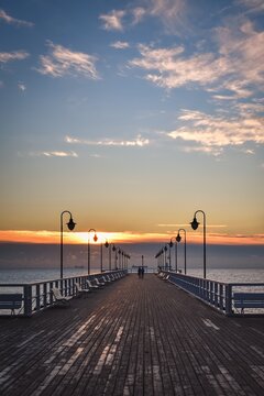 Beautiful morning seaside landscape. Wooden pier with a colorful sky in Gdynia Orlowo, Poland. © shadowmoon30
