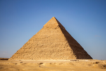 Obraz na płótnie Canvas Pyramid Khafre with row of walking camels Giza, Cairo, Egypt