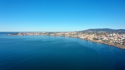 huge and big blue ocean with cascais behind