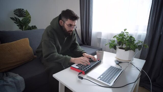 Hobby and creativity concept. Musician is recording tunes on his computer music