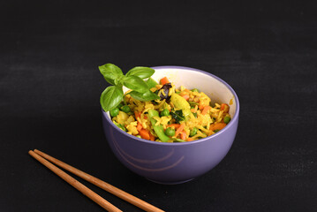 Rice with vegetables and yellow seasoning in a plate.