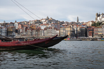 Rabelo boat on the Douro river with the city of Porto in the background.