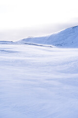 Fototapeta na wymiar Snowy hills with nobody