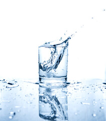 Fototapeta na wymiar Drinking water splashed with ice in glass