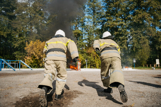 firefighters run to the fire. High quality photo