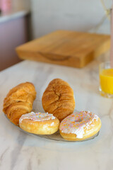 plate of donuts  on a table in a modern kitchen