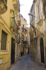 Fototapeta na wymiar Narrow and picturesque street on Ortigia Island in Siracusa, Sicily, Italy