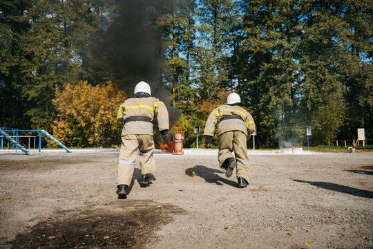 firefighters run to the fire. High quality photo