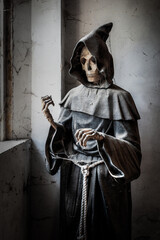 Naklejka premium November 2021, Urbex Italy, disturbing statue depicting death, in an abandoned house